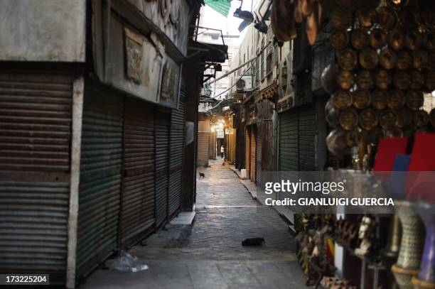 An empty alley is seen at the Khan el-Khalili market as Egyptian Muslims prepare to break their fast after performing the sunset prayer at the end of...