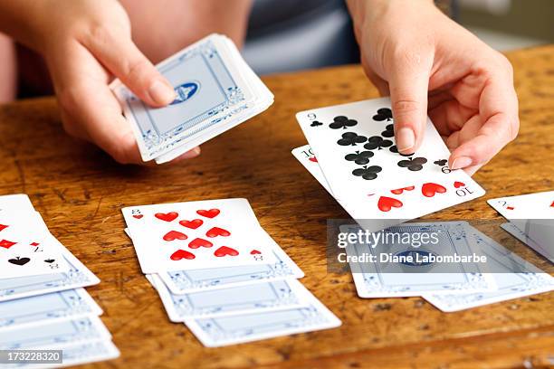 hands playing solitaire card game - solitaire stock pictures, royalty-free photos & images