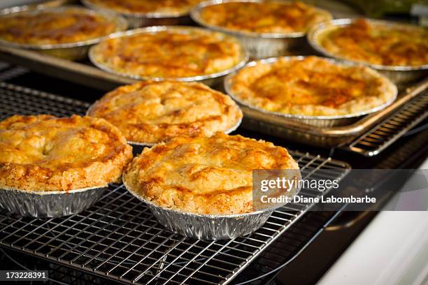 homemade chicken pot pies cooling on rack - meat pie stockfoto's en -beelden
