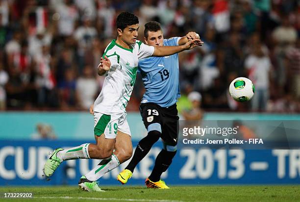 Farhan Shakor of Iraq and Jose Gimenez of Uruguay compete for the ball during the FIFA U-20 World Cup Semi Final match between Iraq and Uruguay at...