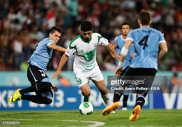 Farhan Shakor of Iraq and Jose Gimenez of Uruguay compete for the ball during the FIFA U-20 World Cup Semi Final match between Iraq and Uruguay at...