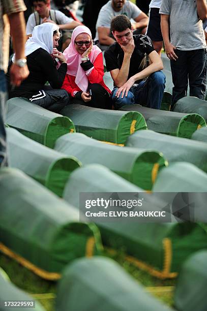 Bosnian Muslim women, survivors of Srebrenica 1995 massacre, mourn near body casket of their relative, at memorial cemetery in village of Potocarion...