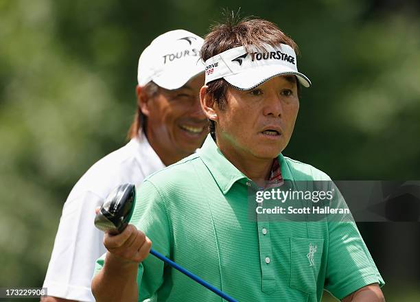 Joe Ozaki and Kohki Idoki of Japan walk off a tee box during a practice round prior to the start of the 2013 U.S. Senior Open Championship at Omaha...