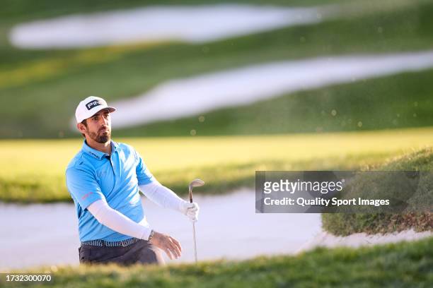 Matthieu Pavon of France watches his shot on the 18th hole during Day One of the acciona Open de Espana presented by Madrid at Club de Campo Villa de...