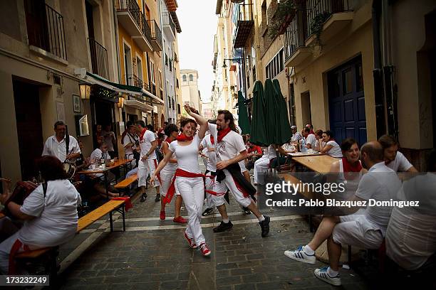 Revellers dance while musicians from Oberena play traditional Basque Country music in the street after having lunch on the fifth day of the San...