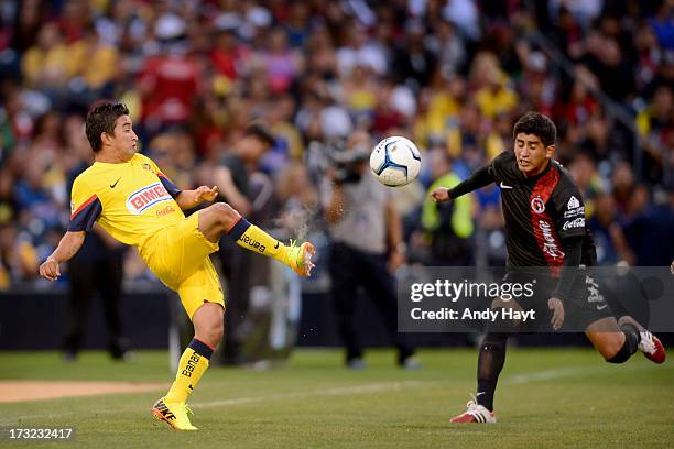 Emmanuel Cerda of the Tijuana Xolos attempts to stop a kick by Christian Bermudez of Club America in a LIGA MX Soccer match at Petco Park on July 6,...