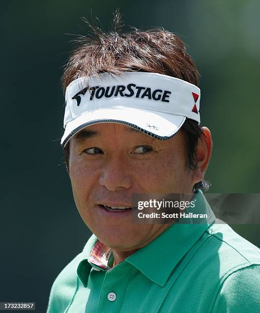 Joe Ozaki of Japan waits on the practice ground during a practice round prior to the start of the 2013 U.S. Senior Open Championship at Omaha Country...