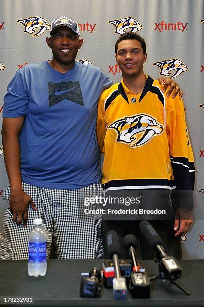 Nashville Predators player Seth Jones poses with his father Popeye Jones after signing a three-year entry-level deal with the Nashville Predators at...