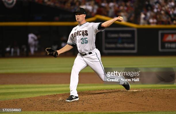Joe Mantiply of the Arizona Diamondbacks delivers a pitch against the Los Angeles Dodgers during Game Three of the Division Series at Chase Field on...