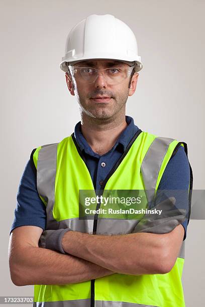 manual worker portrait wearing safety gear - arbetshjälm bildbanksfoton och bilder