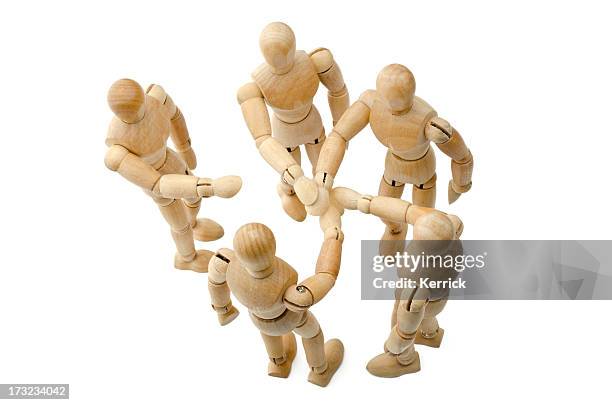 all for one - wooden mannequin putting hands together - lay figure stock pictures, royalty-free photos & images