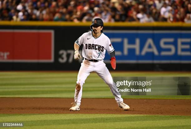 Corbin Carroll of the Arizona Diamondbacks takes a lead from second base against the Los Angeles Dodgers during Game Three of the Division Series at...