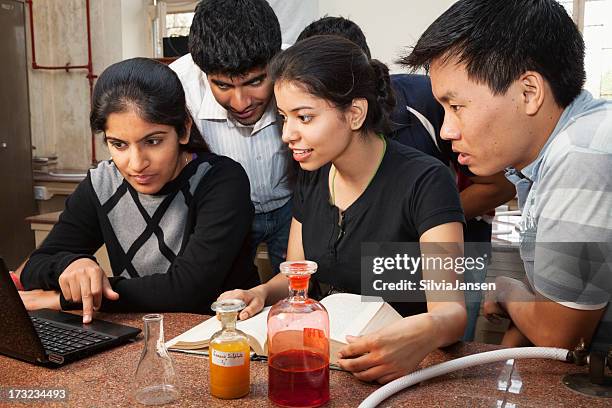 student teamwork research with pc and book - indian subcontinent stock pictures, royalty-free photos & images