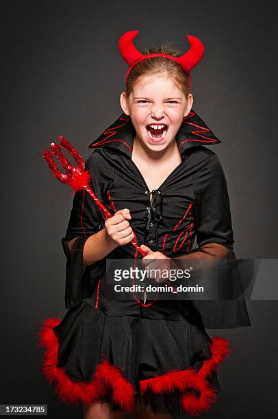 girl in devil costume laughing and screaming, isolated on black - devil stock pictures, royalty-free photos & images