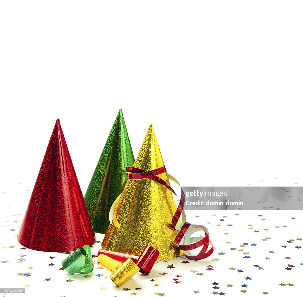 Group of party hats, whistles, streamers, confetti, isolated on white