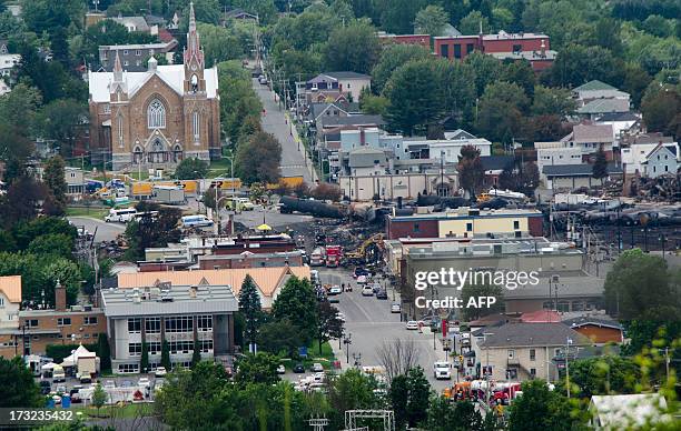 Scorched oil tankers remain on July 10, 2013 at the train derailment site in Lac-Megantic, Quebec. Edward Bukhardt, CEO of Montreal, Maine and...