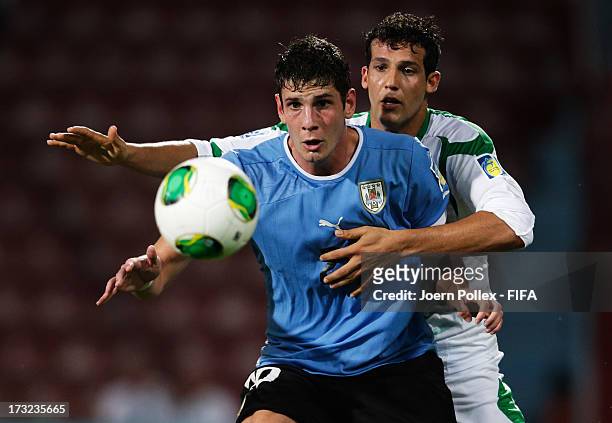 Suad Natiq of Iraq and Felipe Avenatti of Uruguay compete for the ball during the FIFA U-20 World Cup Semi Final match between Iraq and Uruguay at...