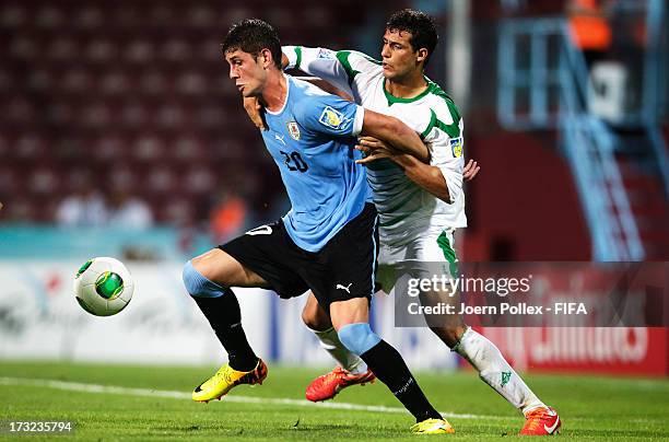 Suad Natiq of Iraq and Felipe Avenatti of Uruguay compete for the ball during the FIFA U-20 World Cup Semi Final match between Iraq and Uruguay at...