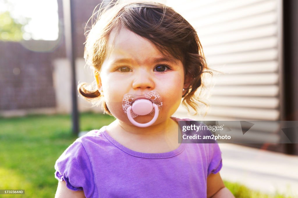Toddler with pacifier in the mouth