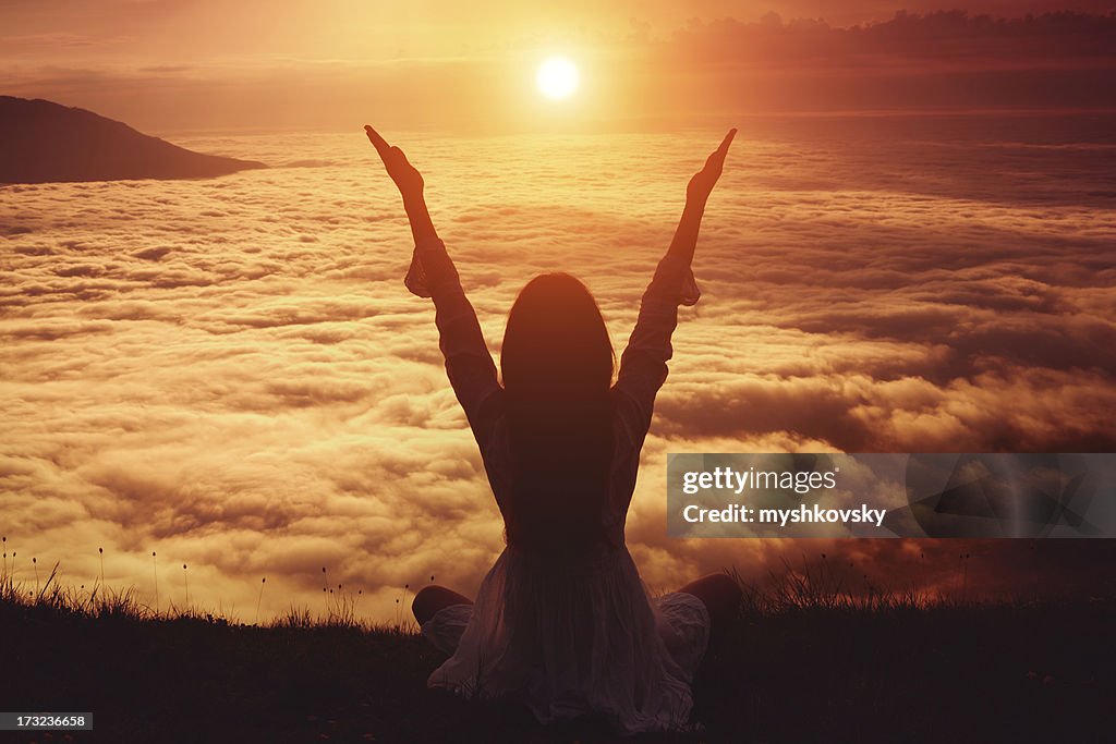 Woman lifting her arms in immense joy