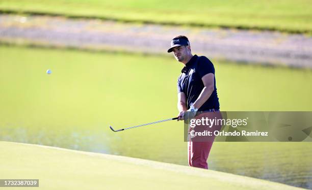 Beau Hossler of the United States chips on the 18th green during the first round of the Shriners Children's Open at TPC Summerlin on October 12, 2023...