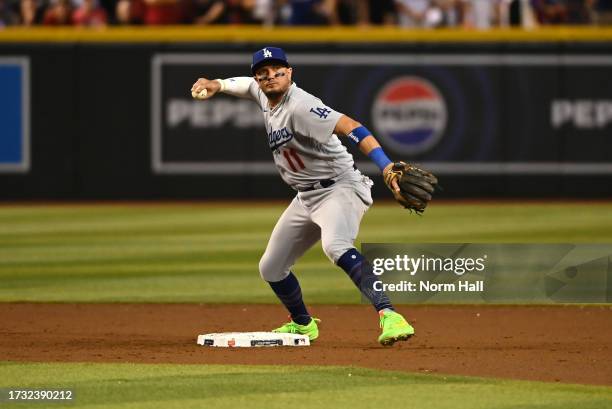 Miguel Rojas of the Los Angeles Dodgers throws the ball to first base against the Arizona Diamondbacks during Game Three of the Division Series at...