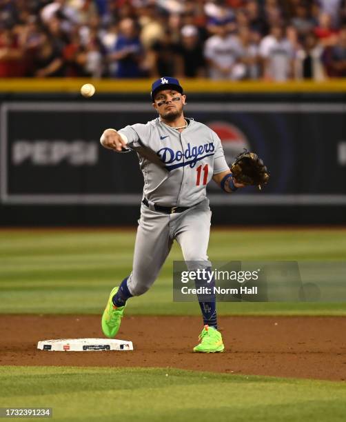 Miguel Rojas of the Los Angeles Dodgers throws the ball to first base against the Arizona Diamondbacks during Game Three of the Division Series at...