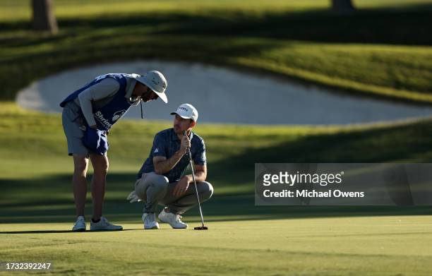 Nick Taylor of Canada and caddie Dave Markle prepare to putt on the 16th green during the first round of the Shriners Children's Open at TPC...