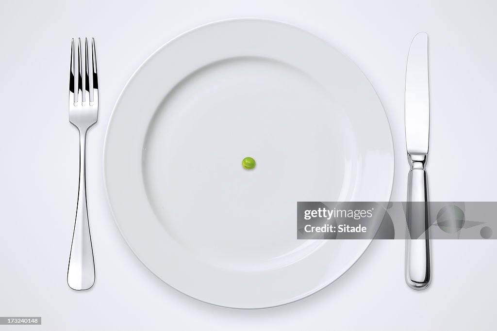One Green Pea On Plate. Table Setting With Clipping Path.