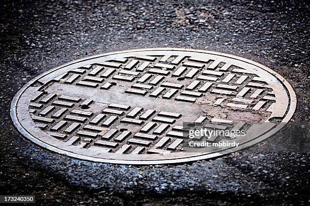 manhole cover on street - manhole stock pictures, royalty-free photos & images