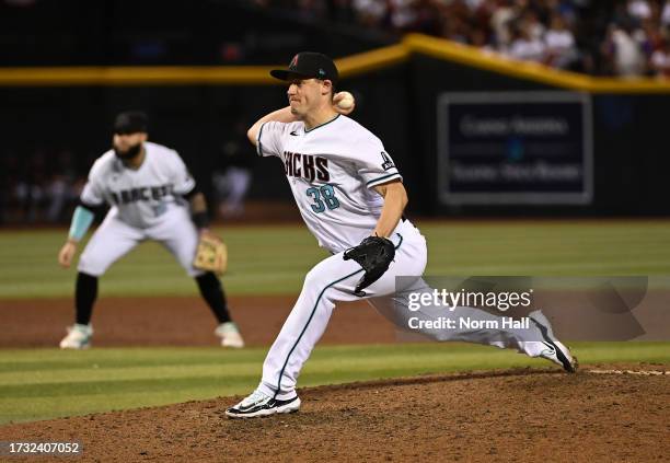 Paul Sewald of the Arizona Diamondbacks delivers a pitch against the Los Angeles Dodgers during Game Three of the Division Series at Chase Field on...