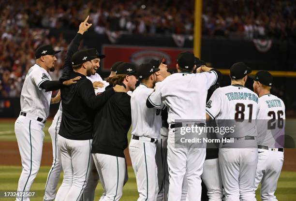 The Arizona Diamondbacks celebrate a win against the Los Angeles Dodgers during Game Three of the Division Series at Chase Field on October 11, 2023...