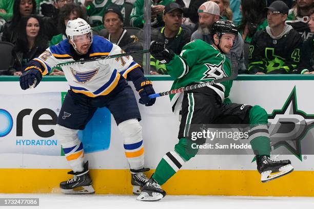 Justin Faulk of the St. Louis Blues and Craig Smith of the Dallas Stars get tangled up during the first period at American Airlines Center on October...