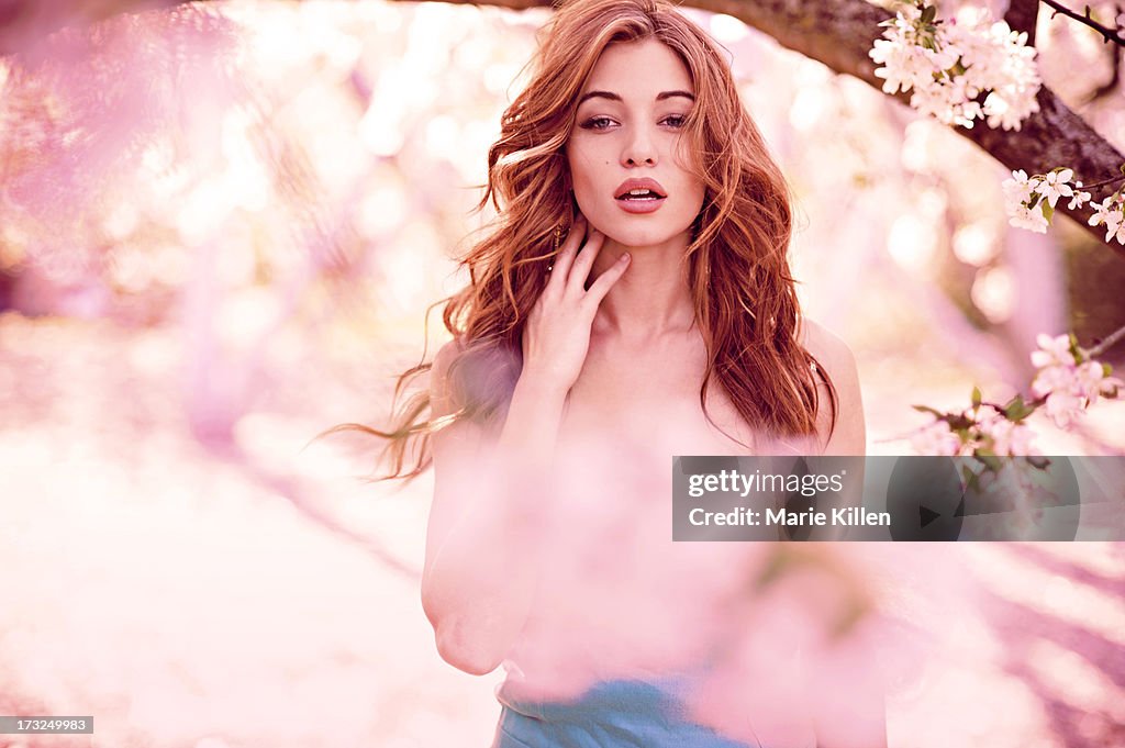 Beautiful woman surrounded by pink flowers