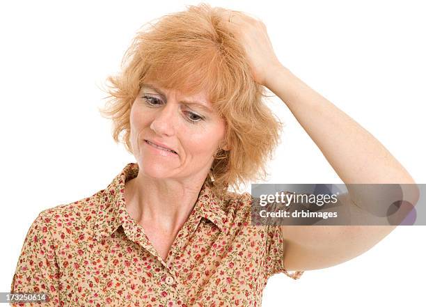 uncertain mature woman scratches head - scratching head stock pictures, royalty-free photos & images