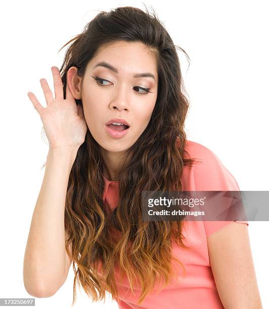young woman listening with hand to ear - eavesdropping stock pictures, royalty-free photos & images