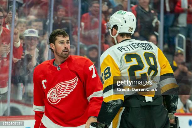 Dylan Larkin of the Detroit Red Wings and Marcus Pettersson of the Pittsburgh Penguins have words before a fight during the second period at Little...