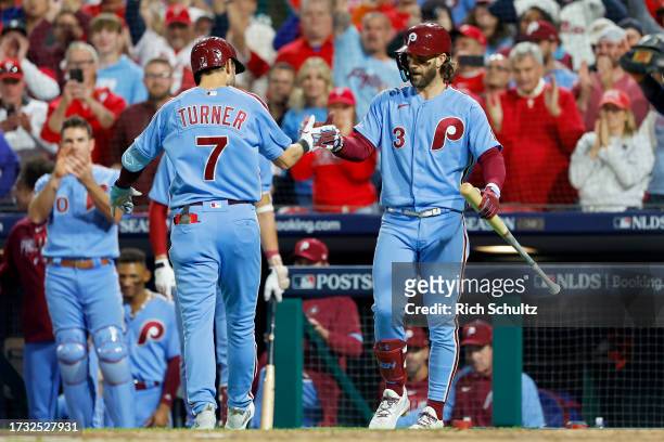 Trea Turner and Bryce Harper of the Philadelphia Phillies celebrate after Turner hit a home run in the fifth inning against the Atlanta Braves during...