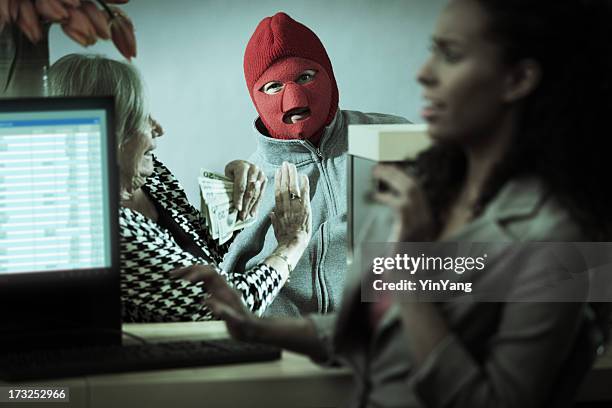 robber with teller and customer in retail bank window - bank robber stock pictures, royalty-free photos & images