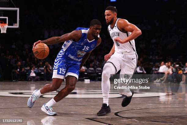 Dwayne Bacon of Maccabi Ra'anana drives to the net against Ben Simmons of the Brooklyn Nets during an exhibition game at Barclays Center on October...