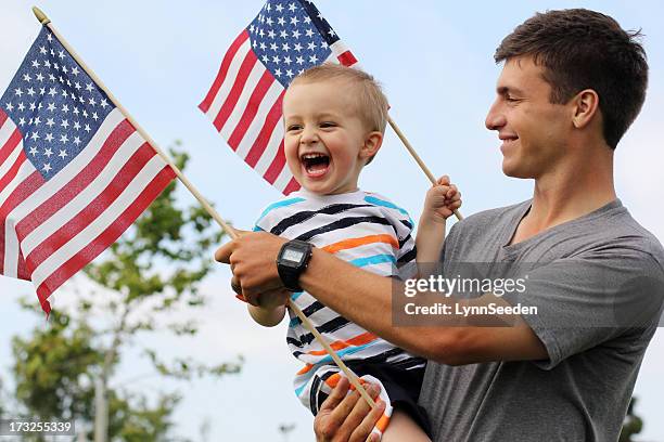 patriotische vater und sohn - patriotic flags stock-fotos und bilder