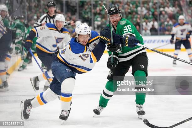 Robert Thomas of the St. Louis Blues and Matt Duchene of the Dallas Stars battle for the puck during the second period of their season opener at...