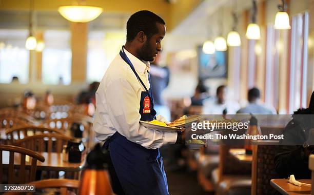Jonathan Taylor serves customers at IHOP on Alabama Avenue SE on February 16 in Washington, DC. DC's population east of the Anacostia River makes up...