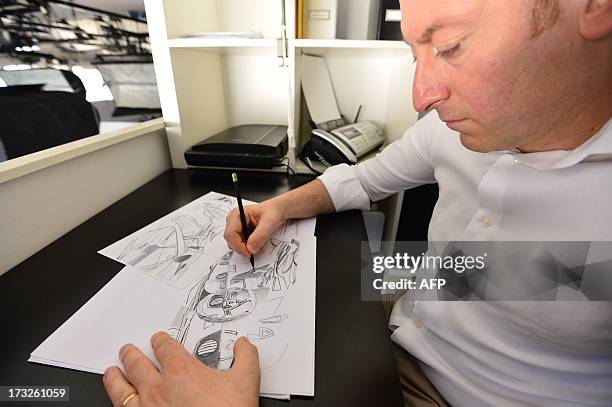 Head of the Mazzanti Automobili , Luca Mazzanti works on a draing of an Evantra supercar on July 9, 2013 in the workshop of Mazzanti Automobili in...