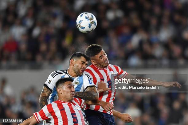 Cristian Romero of Argentina jumps for the ball against Richard Ortiz and Fabian Balbuena of Paraguay during the FIFA World Cup 2026 Qualifier match...