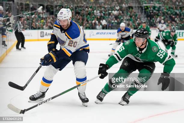 Brandon Saad of the St. Louis Blues and Thomas Harley of the Dallas Stars compete for the puck during overtime in the season opener at American...