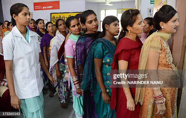 Pregnant Indian women wait for a check-up at a government hospital in Amritsar on July 11 on the occasion of World Population Day. Africa and Asia...