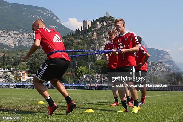 Arjen Robben of FC Bayern Muenchen and his team mate Mitchell Weiser during a training session at Campo Sportivo on July 11, 2013 in Arco, Italy