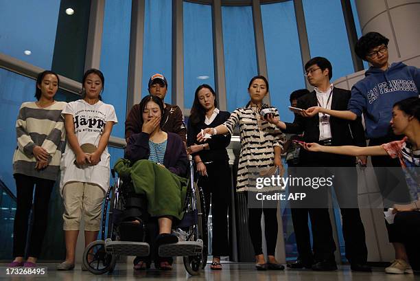 Flight attendants who were working on Asiana Airlines flight 214 that crashed at San Francisco Airport speak to the media after arriving at Incheon...
