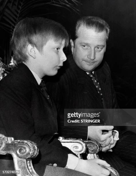 Picture released on March 25, 1972 of Crown Prince Philippe of Belgium sitting near his father Albert II of Belgium at the center for Fine Arts,...
